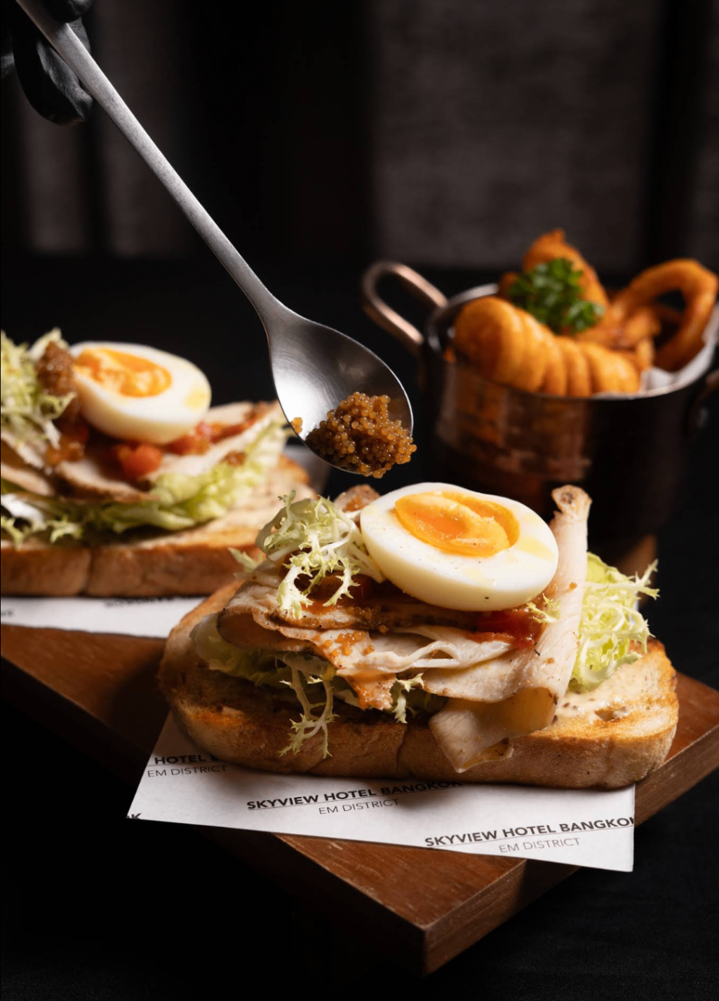 Open-faced sandwich with soft-boiled egg and garnish
