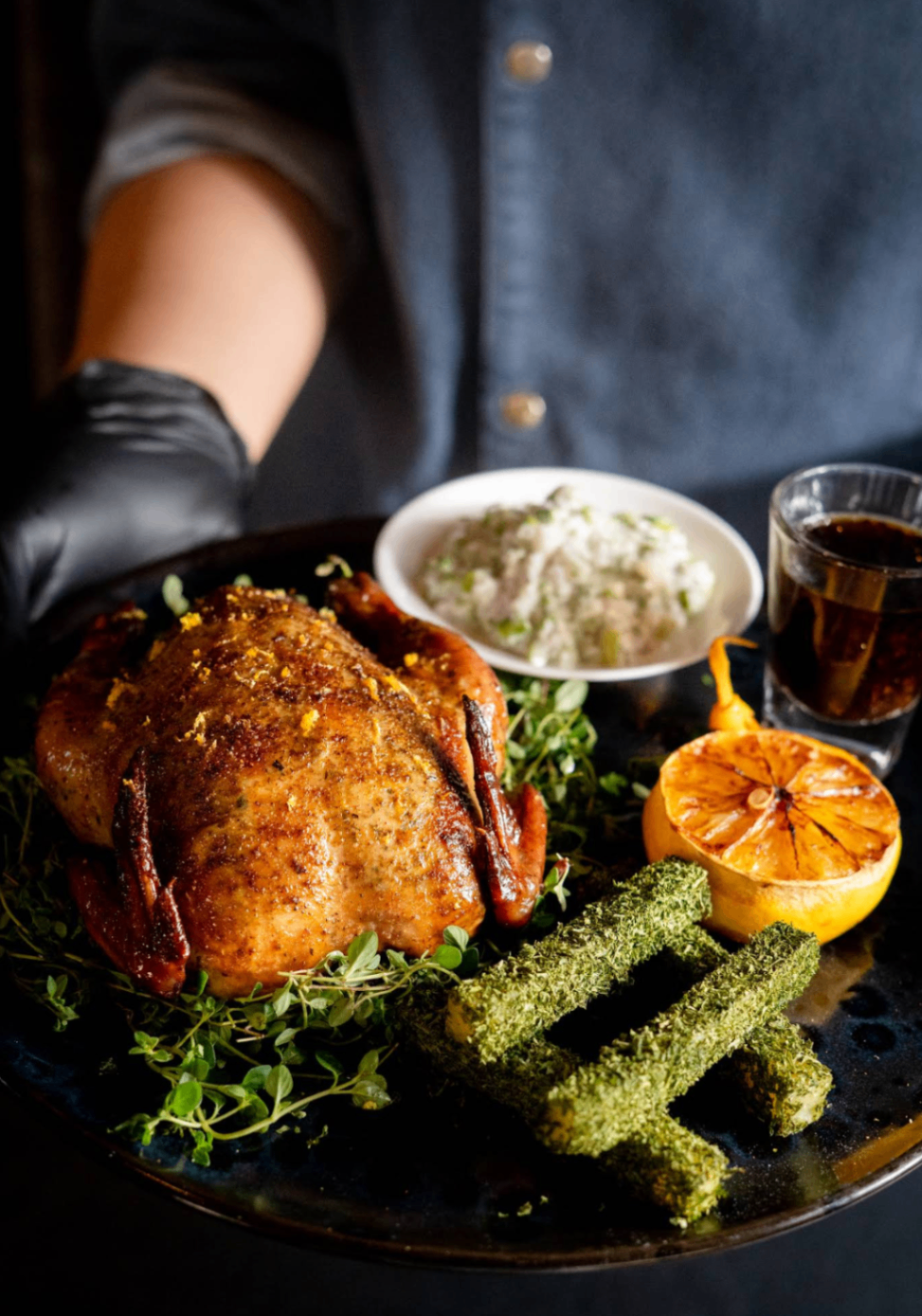 Roast chicken dish with charred lemon and sides
